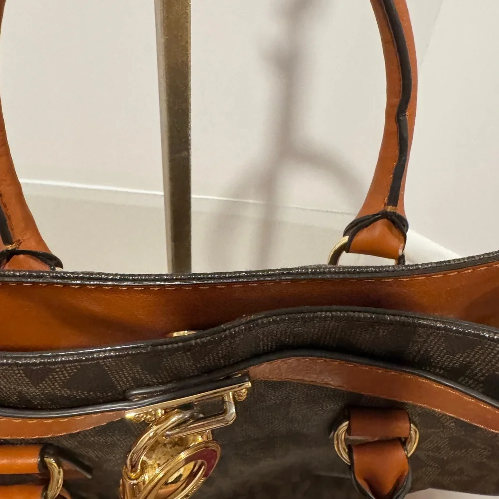 Michael Kors Emblemed satchel style purse. Strap has some gold chain and leather